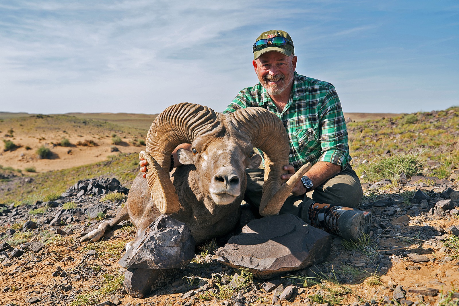 Mike Axelrad with a giant Argali ram on the Mongolian steppe