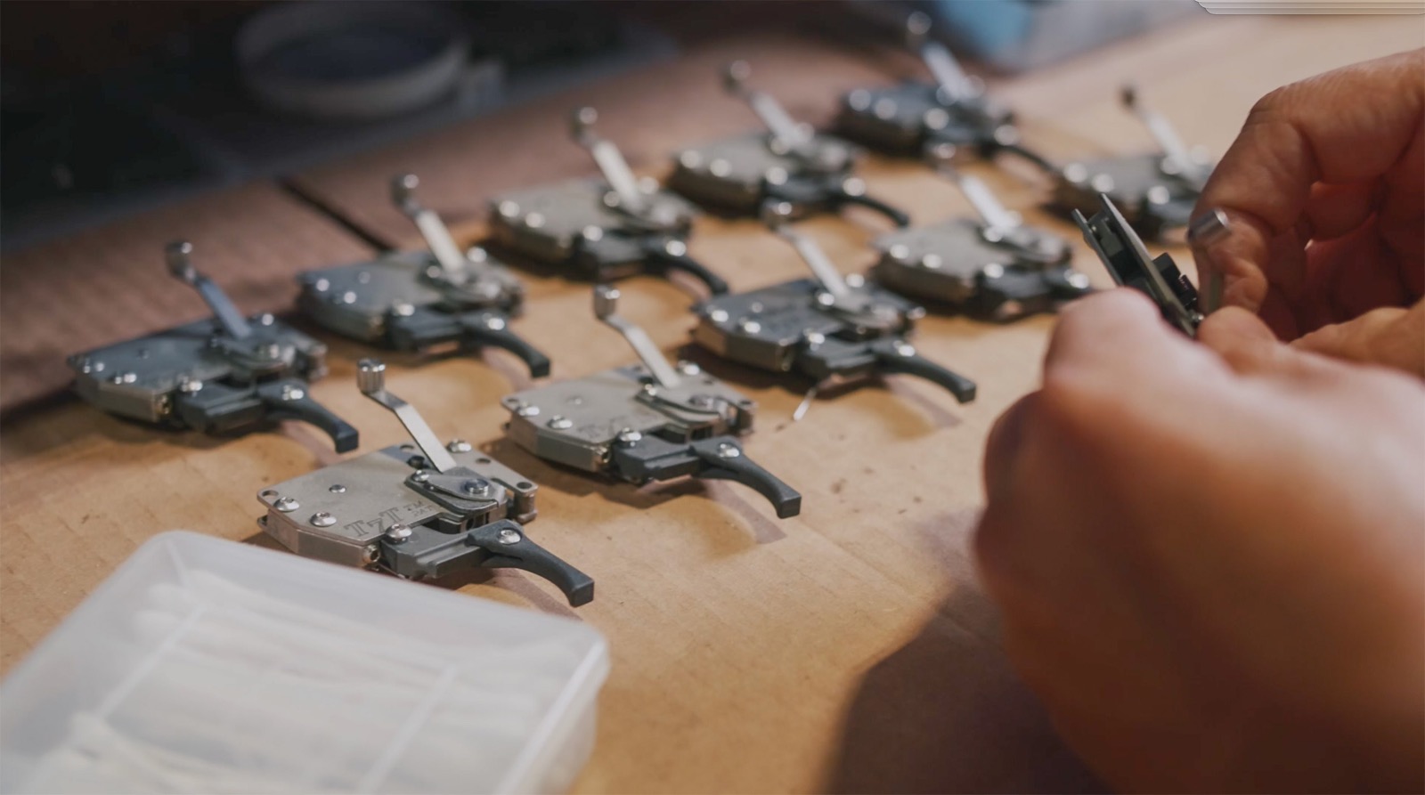 Trigger assemblies laid out on the bench at Superior Shooting Supplies